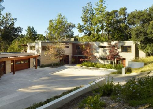 Irregularly shaped house with a small grove of eucalyptus and pine trees 32 554x354